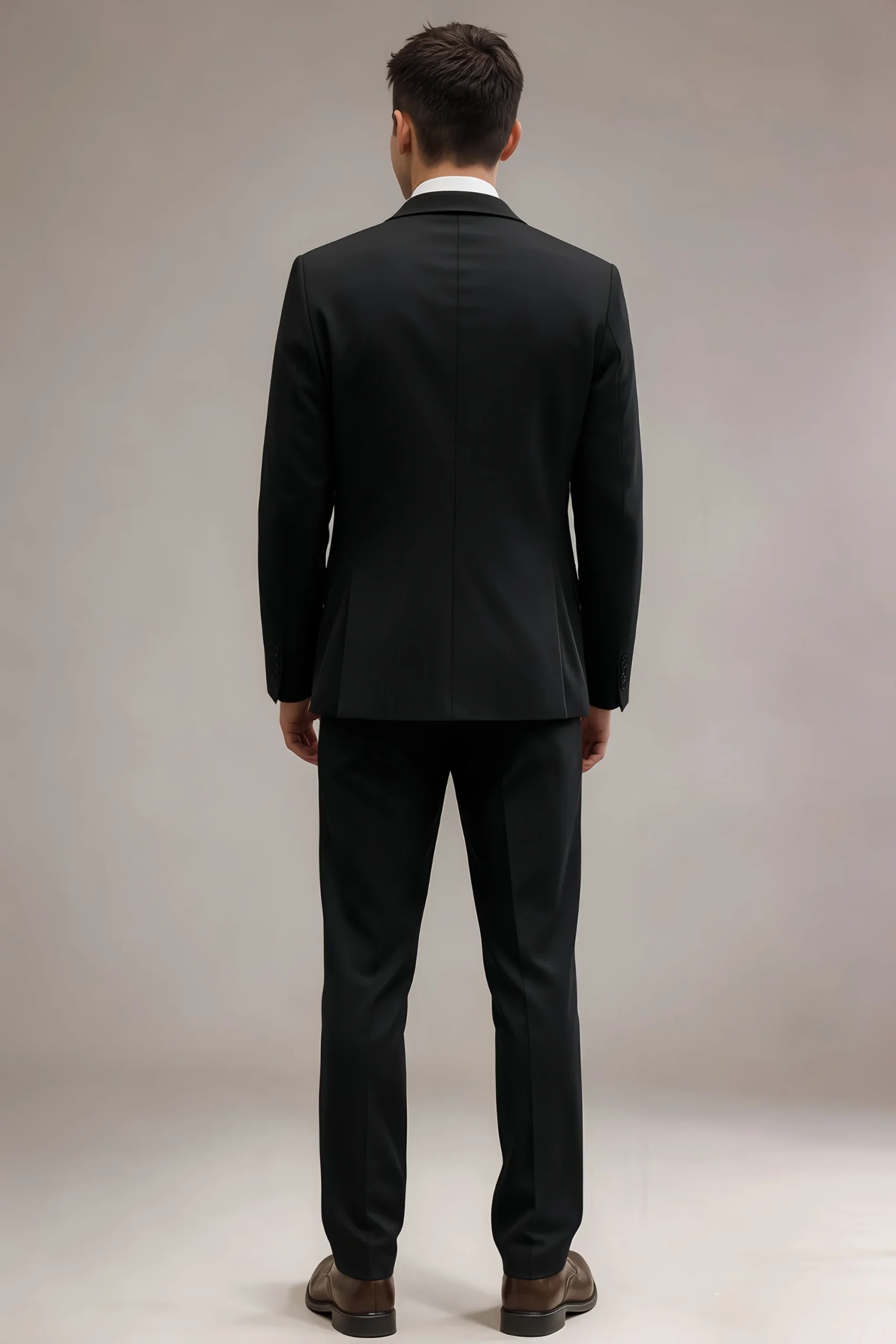 Back view of LILVS Jago black slim-fit suit jacket showing clean center seam and structured back, paired with trousers